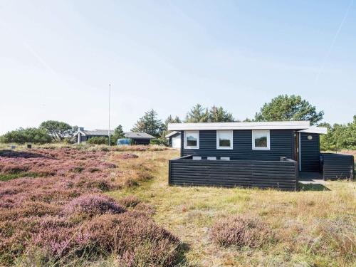 a tiny house sitting in a field of grass at 4 person holiday home in Fanø-By Traum in Fanø