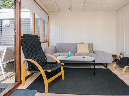 a living room with a couch and a table and chairs at 4 person holiday home in Fanø-By Traum in Fanø
