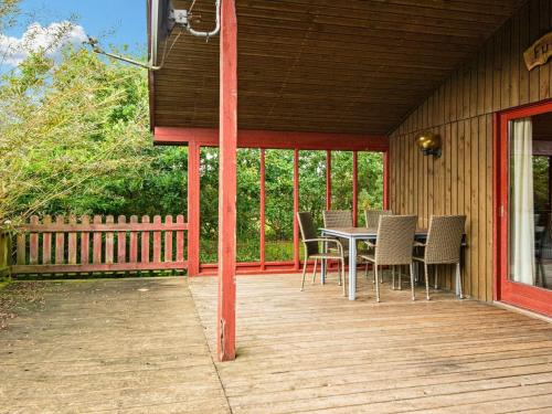 a wooden deck with a table and chairs on it at 6 person holiday home in Struer-By Traum in Struer