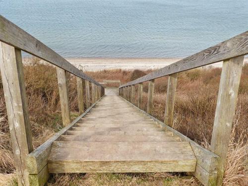 a wooden boardwalk leading to the beach at 6 person holiday home in Struer-By Traum in Struer