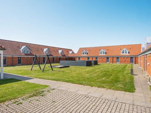a school yard with a playground in front of a building at 6 person holiday home in Lemvig-By Traum in Lemvig