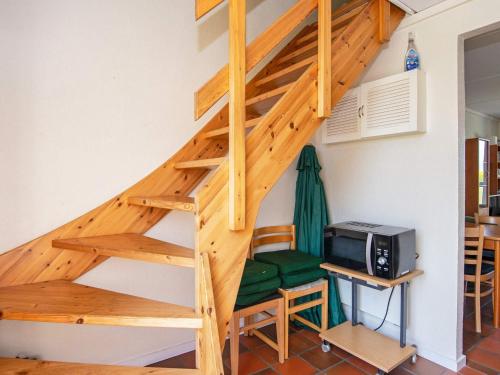 a wooden staircase in a room with a microwave at 6 person holiday home in Lemvig-By Traum in Lemvig