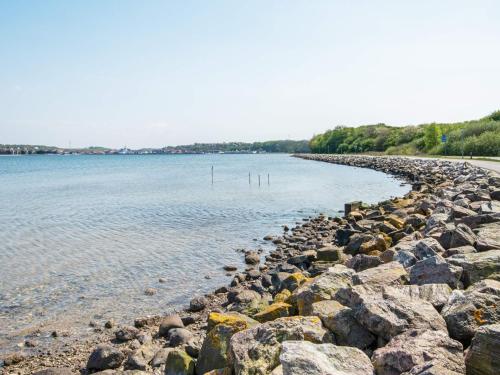 a large group of rocks on the shore of a body of water at 6 person holiday home in Lemvig-By Traum in Lemvig