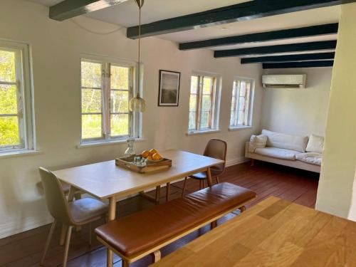 a dining room with a table and a couch at 6 person holiday home in Skagen-By Traum in Skagen