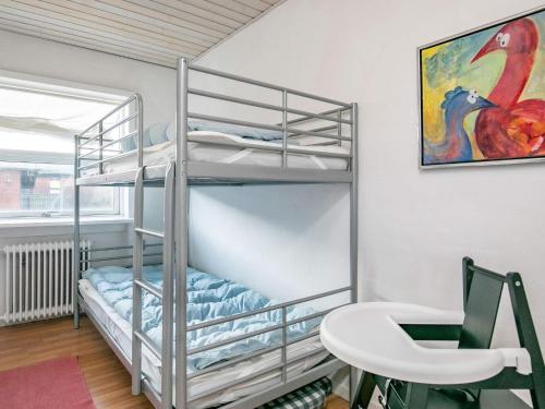 una litera en una habitación con un escritorio y una mesa en 8-Person Home in Skagen-By, en Skagen