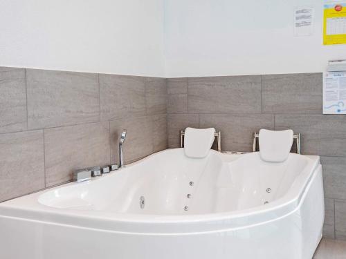 a large white bath tub in a bathroom at Luxury Retreat in Klitmoller - By Traum Ferienwohnungen in Torsted
