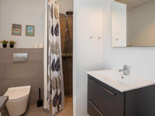 a bathroom with a sink and a shower curtain at Luxury Retreat in Klitmoller - By Traum Ferienwohnungen in Torsted