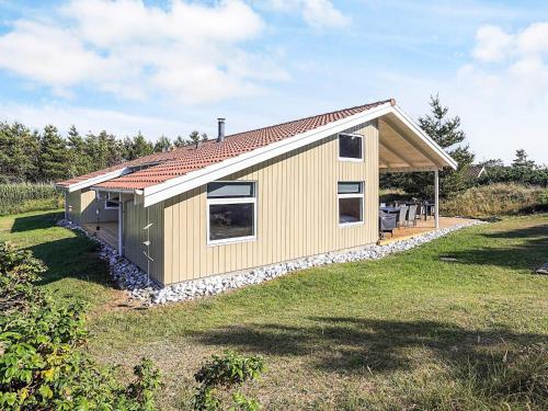 a small shed with a roof on a grass field at Luxury Retreat in Klitmoller - By Traum Ferienwohnungen in Torsted