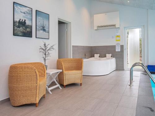 a bathroom with a bath tub and wicker chairs at Luxury Retreat in Klitmoller - By Traum Ferienwohnungen in Torsted