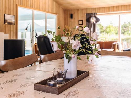 a vase of flowers sitting on a table at Luxury Retreat in Klitmoller - By Traum Ferienwohnungen in Torsted