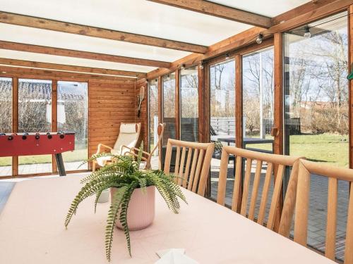 a screened in porch with a table and chairs at 8 person holiday home in Vinderup-By Traum in Vinderup