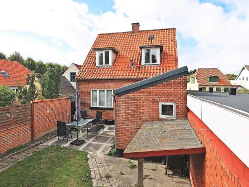 a brick house on a roof with a patio at 3 person holiday home in Ærøskøbing-By Traum in Ærøskøbing