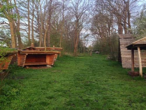 a yard with a wooden building in the grass at 3 person holiday home in Ærøskøbing-By Traum in Ærøskøbing