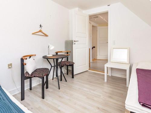 a room with a table and chairs and a bed at 3 person holiday home in Ærøskøbing-By Traum in Ærøskøbing