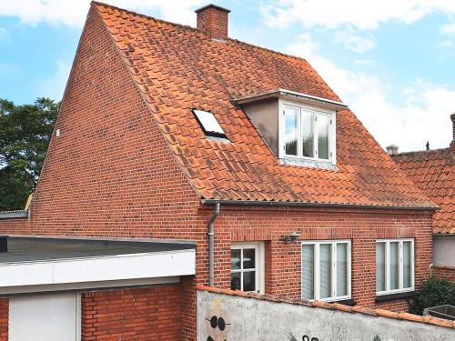 a house with an orange roof with two windows at 3 person holiday home in Ærøskøbing-By Traum in Ærøskøbing