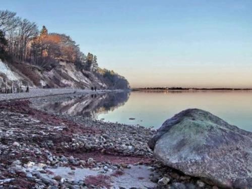 a large rock on the shore of a body of water at Scenic Retreat in Boddum - By Traum Ferienwohnungen in Boddum