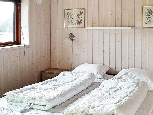 two unmade beds in a room with at 6 person holiday home in Sydals-By Traum in Neder Lysabild