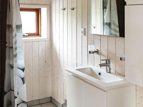 a white bathroom with a sink and a window at 6 person holiday home in Sydals-By Traum in Neder Lysabild