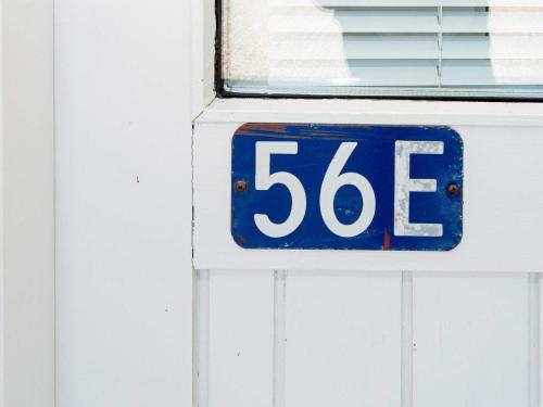 a blue and white sign on a garage door at Seaside Retreat in Kegnaes - By Traum Ferienwohnungen in Østerby
