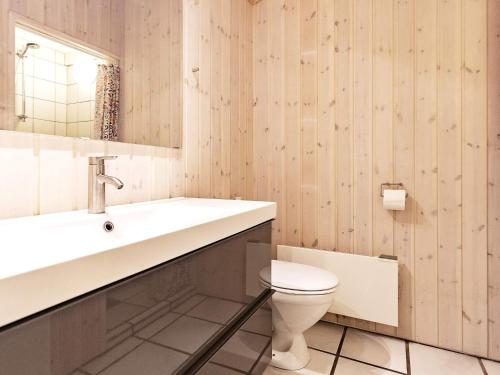 une salle de bain avec un lavabo et des toilettes dans l'établissement Luxury Pool House Retreat - By Traum Ferienwohnungen, à Saltum