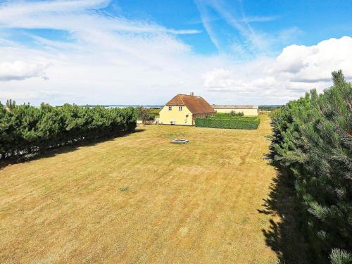 an empty field with a house in the background at 6 person holiday home in Faaborg-By Traum in Fåborg
