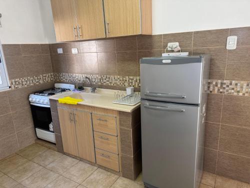 a small kitchen with a refrigerator and a sink at Atrapasueños fiambala in Tinogasta