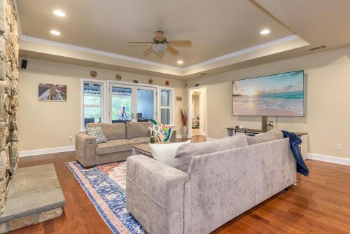 a living room with two couches and a ceiling fan at The Blue Resort of Yosemite - Pool, Spa, Games in Mariposa