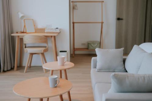 a living room with a couch and two tables at 與浪共舞 in Xiyu
