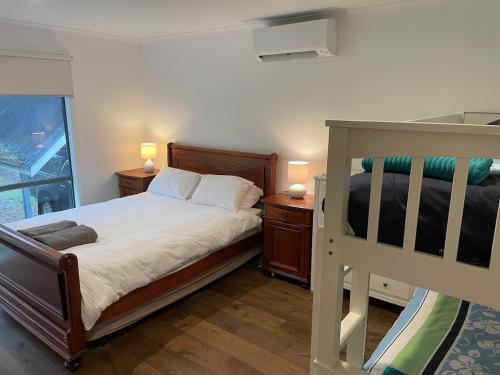 a bedroom with two bunk beds and a window at Beachside Phillip Island in Cowes