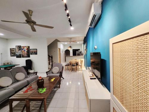 a living room with a couch and a table at Ipoh pasir puteh vibrant home 4br 15 pax in Ipoh