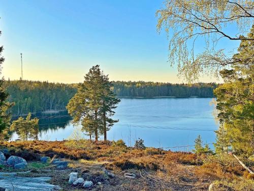 a lake with a tree in the middle of it at 7 person holiday home in VÄRMDÖ-By Traum in Värmdö