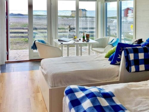 two beds in a room with a view of the ocean at 3 person holiday home in LÖTTORP-By Traum in Löttorp