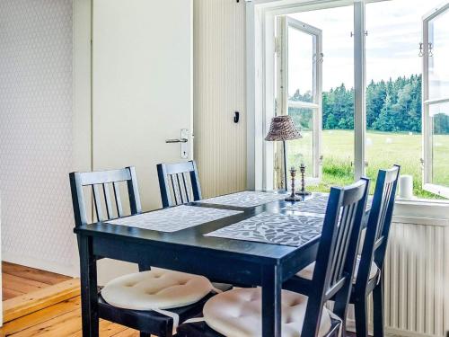 a dining room with a black table and chairs at 5 person holiday home in FLEN-By Traum in Flen