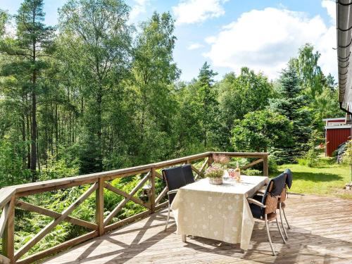 a table and chairs on a wooden deck at 8 person holiday home in SKÅNES FAGERHULT-By Traum in Skånes Fagerhult
