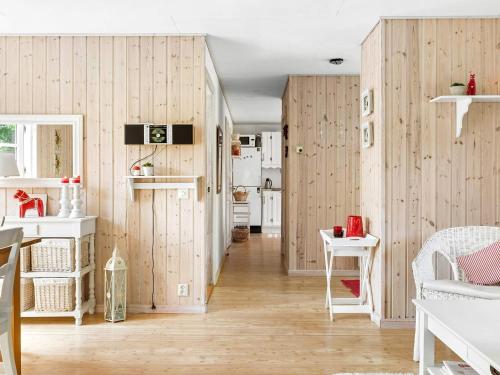 a living room with wooden walls and wooden floors at 8 person holiday home in SKÅNES FAGERHULT-By Traum in Skånes Fagerhult