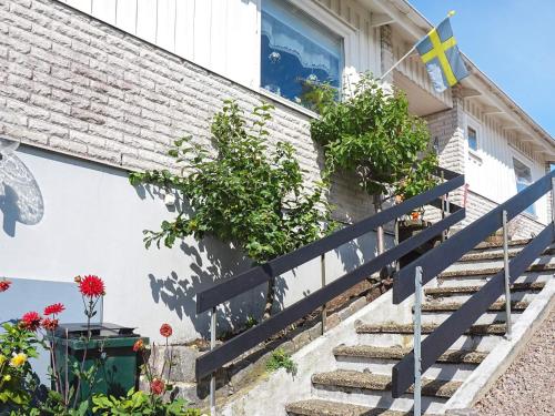 a house with stairs and flowers in front of it at 4 person holiday home in KUNGSHAMN-By Traum in Kungshamn