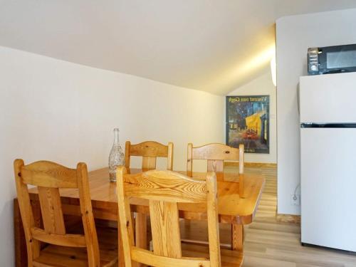 a kitchen with a wooden table and chairs and a refrigerator at 4 person holiday home in KUNGSHAMN-By Traum in Kungshamn