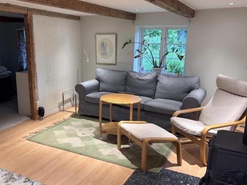 a living room with a couch and a table at 6 person holiday home in ÖRKELJUNGA in Orkelljunga