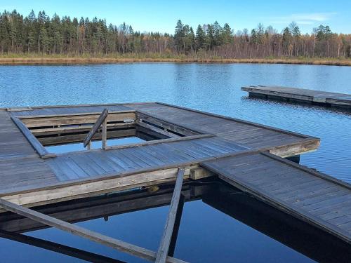 a wooden dock in the middle of a lake at 5 person holiday home in STAVSJÖ-By Traum in Stavsjo
