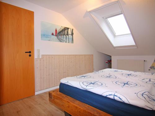 a bedroom with a bed and a skylight at Holiday Complex Orther Reede Fehmarn in Orth