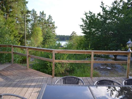 a wooden deck with a table and chairs on it at 5 star holiday home in LJUSTERÖ in Norra Ljustero