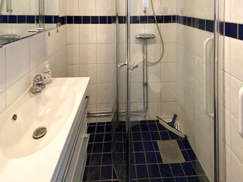 a bathroom with a glass shower and a sink at 5 star holiday home in LJUSTERÖ in Norra Ljustero