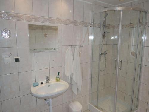 a bathroom with a sink and a shower at Mi dzyzdroje Terraced House near Promenade in Międzyzdroje