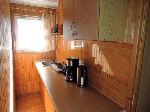 a kitchen with a counter with a coffee maker on it at Bungalow near the Baltic Sea Beach in Wrzosowo