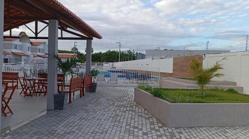 a patio with a table and chairs and a table and chairs at Casa duplex em Parnaíba - casa73phb in Parnaíba