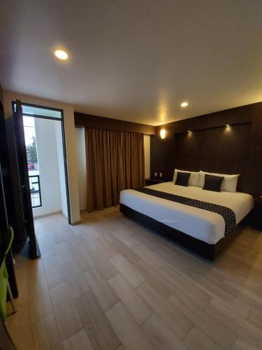 Una cama o camas en una habitación de Hotel La Estancia Zacatlan