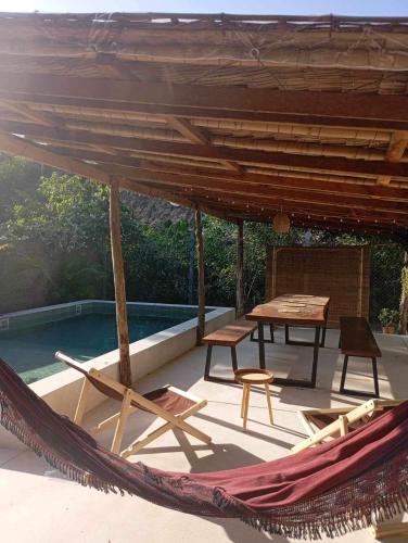 a hammock on a patio with a table and chairs at Les Twins in Hinkong