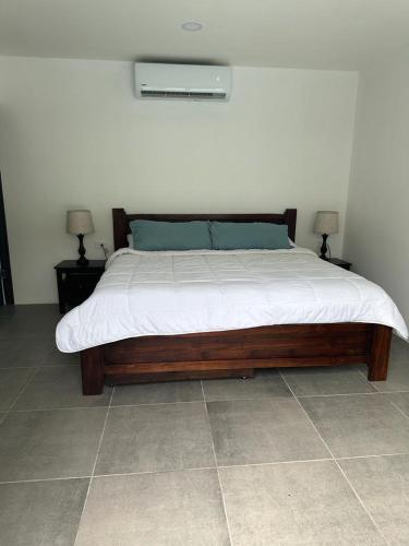 a bed in a room with two nightstands and two lamps at Casa Luna in Santa Cruz