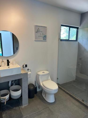 a bathroom with a toilet and a sink and a shower at Casa Luna in Santa Cruz