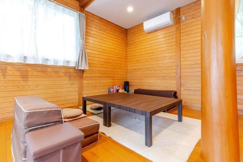a dining room with a table and a chair at 一棟貸切別荘 神氣龍 in Sagamihara